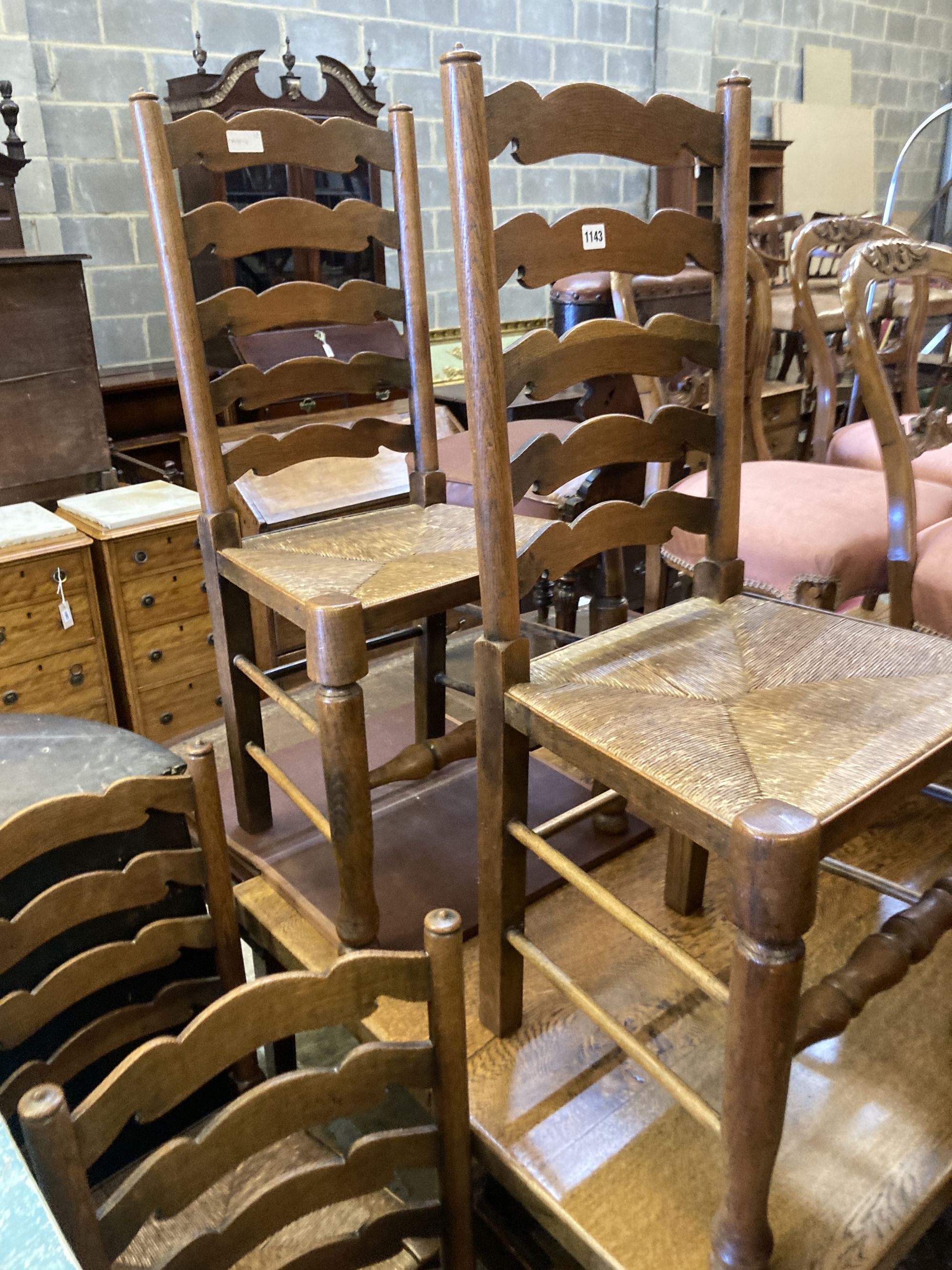 A set of six oak rush seated ladderback dining chairs